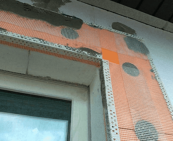 Устанавливают профильные уголки на углы здания, а также, дверные и оконные проемы